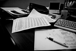 tax papers left on desk in black and white - Melville, NY CPAs